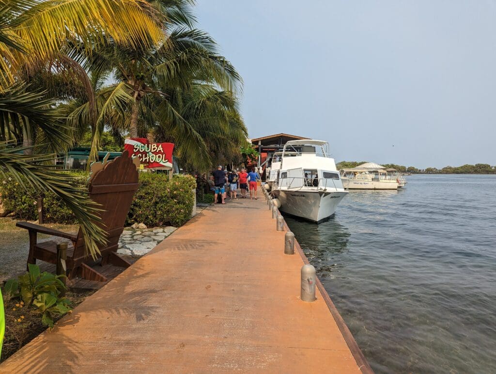 A dive boat at the end of a long dock in Roatan.