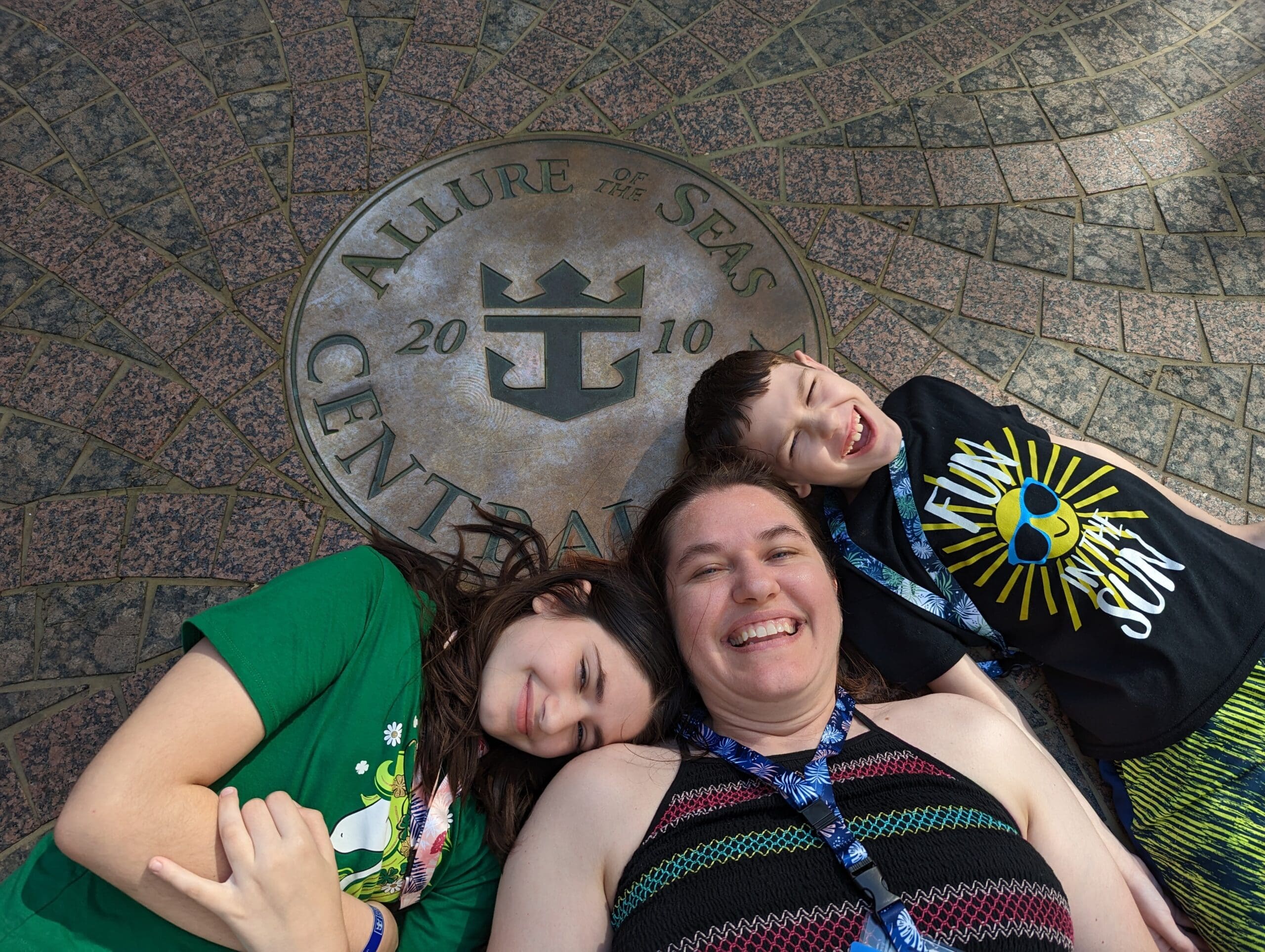 A family poses with the seal for Allure of the Seas