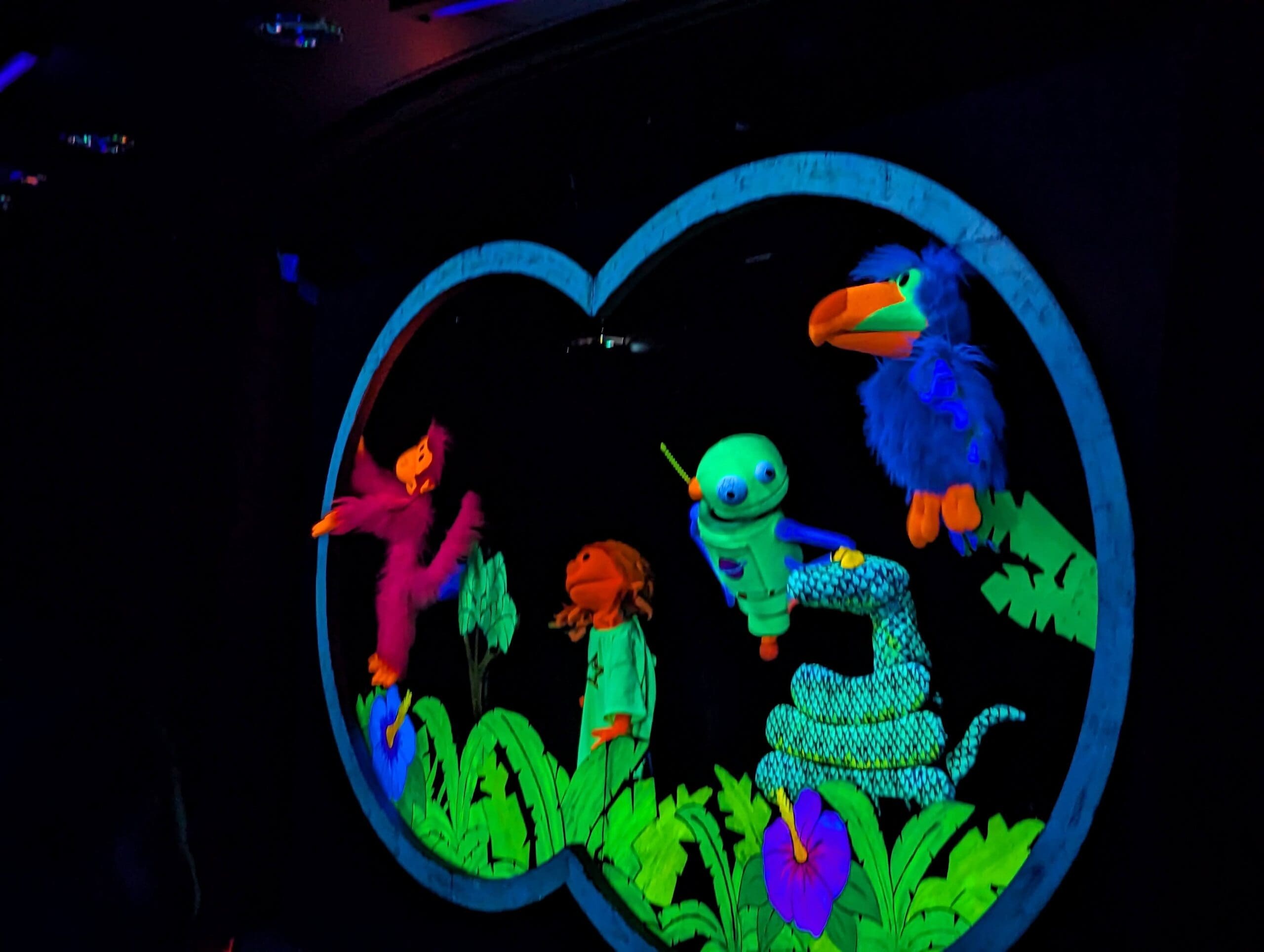 A scene from the glow in the dark puppet show.